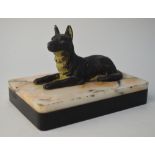 A cold-painted spelter recumbent dog, mounted on a marbled slate block base, as a paperweight,