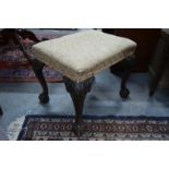 A mahogany dressing stool in the Georgian manner, with upholstered seat on acanthus carved