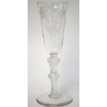 An 18th century ale glass, rounded funnel bowl etched with barley and hops, double-knopped