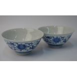 A pair of Chinese blue and white bowls, each one decorated with formal lotus; 9.5 cm diameter.