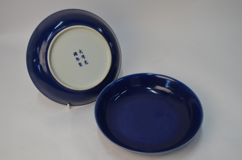 A pair of Chinese blue monochrome saucer dishes, 21 cm diameter.