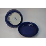 A pair of Chinese blue monochrome saucer dishes, 21 cm diameter.