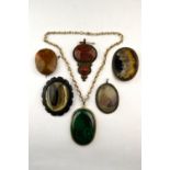 A collection of agate brooches and pendants including gold set pudding stone brooch, scenic agate