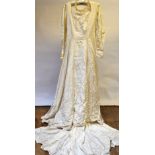 A 1950s cream finely ribbed and floral garlanded wedding dress with head-dress, to/w a collection of
