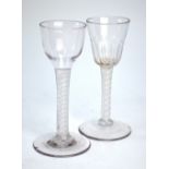 Two 18th century cordial glasses, one with round funnel moulded bowl, multiple spiral opaque twist