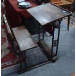 A 19th century school desk and integral seat with cast iron frame and oak panels,