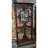 A Victorian carved walnut hallstand set with a bevelled mirror and shelf,