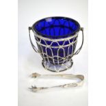 A silver wire sugar basket with swing handle and blue glass liner, Barker Brothers, Chester 1910