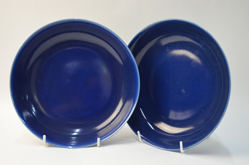 A pair of Chinese blue monochrome saucer dishes; 21 cm diameter.