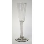 An 18th century ale glass, rounded funnel bowl, double opaque spiral twist stem, conical foot and