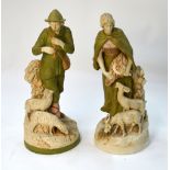 A pair of Royal Dux figures of a Shepherd and Shepherdess; the Shepherd playing an instrument,