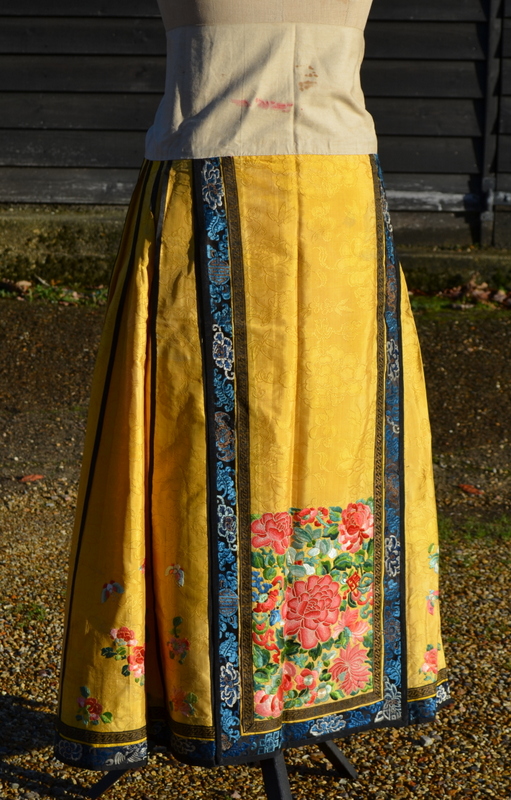 A Chinese imperial-yellow ground textile skirt decorated with floral designs,