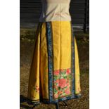 A Chinese imperial-yellow ground textile skirt decorated with floral designs,