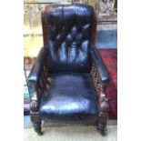 A Victorian mahogany framed black button leather backed library armchair, the overstuffed arms