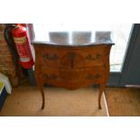 A French inlaid kingwood two-drawer commode in the Louis XV manner, of bombe form with rouge