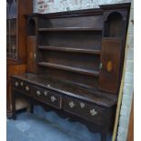 An 18th century style crossbanded oak high dresser, the open three tier top with cupboards to each