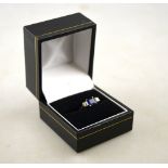 A sapphire and diamond ring, the central square sapphire having diamonds on either side, 18ct