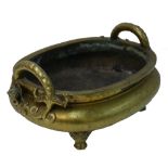 A large Chinese gilt metal incense burner of oval form with mythological animal handles;