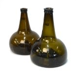 Two early 18th century green glass onion shaped bottles, each with a flattened body and kicked-in