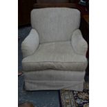 A Howard & Sons armchair, re-upholstered in textured faun fabric, on square tapering supports