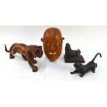 A wood mask of Okame, 20 cm high; together with a wood figure of a striding tiger, 30 cm long; a