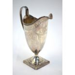 Peter & Ann Bateman - a George III silver cream jug with reeded rim and handle and engraved