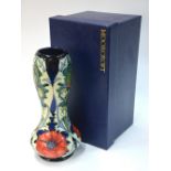 A Moorcroft contemporary vase of waisted form decorated in the 'Poppy' pattern on a blue ground,