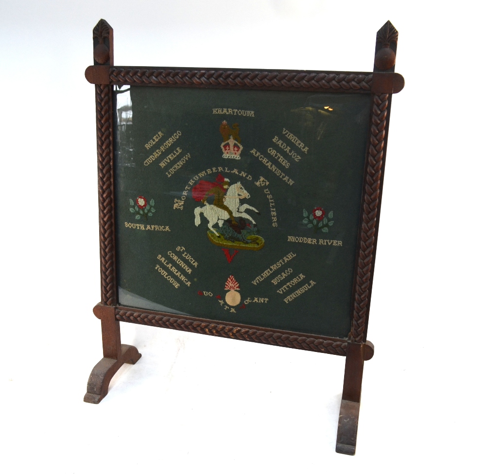 An oak framed fire-guard, carved with grenades and plaited ropes,