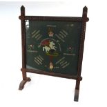 An oak framed fire-guard, carved with grenades and plaited ropes,