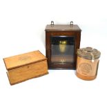 An oak smoker's cabinet with brass tobacco jar, to/w a glass Cuban Cigar Jar for H. Upmann, Havana