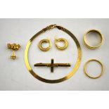 A collection of gold and yellow metal items including bracelet, two wedding bands, two earrings,