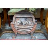 A Regency style cast iron fire basket with brass finials, on scroll front legs, 64 cm high x 58 cm