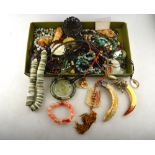 A large collection of jade and green stone jewellery items including necklaces, bangles, pendants