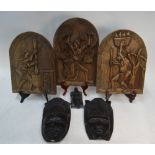 Three African carved wood wall-masks, to/w three relief-carved plaques depicting tribal life (6 -
