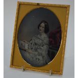 An elegant coloured ambrotype, or other process, of a young women reading a book,