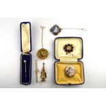 A collection of four antique brooches including allegorical porcelain scene of female with lambs,