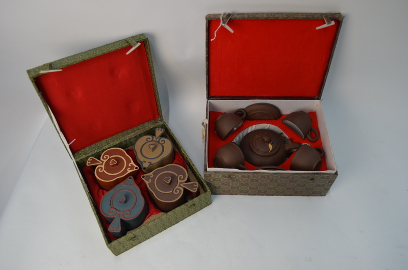 Two Chinese Yi-xing, or other, ceramic sets; each set in a fitted box.