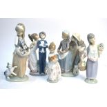 Five Lladro figures including a girl with cat and kittens,