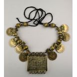 A traditional Middle Eastern necklace having spice box centre between beads and coins threaded onto