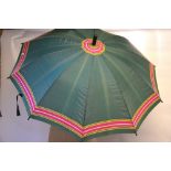 A retro Mary Quant umbrella - green with pink/yellow/cream stripes to edge, black plastic grip