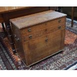 An oak silver-chest with two fitted cutlery drawers and lower fall-front,