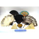 Three ostrich feather fans on tortoiseshell effect frames, a brise cut bone fan with twenty-six ribs