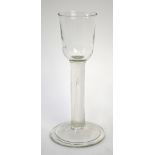 An 18th century cordial glass, ogee bowl, straight stem incorporating an elongated teardrop, fold