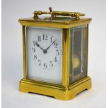 A brass carriage clock, striking on a coiled gong, enamel dial inscribed for Vokes of Bath, 16 cm