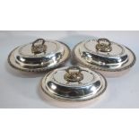 A pair of 19th century plated on copper oval entree dishes and covers with detachable twist handles