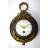 A late 19th century Louis XV style patinated and gilt ormolu and cartel wall clock, the enamelled