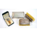 A pair of Art Deco silver-backed hairbrushes, Birmingham 1935, to/w a cigarette box,