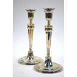 A pair of loaded silver baluster candlesticks with beaded rims and foliate-decorated sconces,