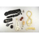A lot containing various antique items including carved jet necklaces, black glass bracelet, glass