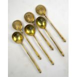 A matched set of six Imperial Russian silver gilt coffee spoons with engraved backs to the bowls